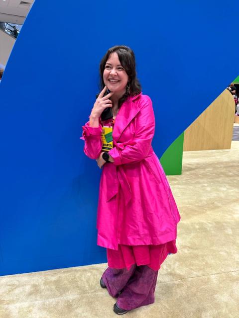 A woman wears a hot pink ensemble