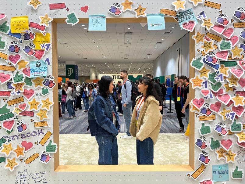 A cut-out in the FigJam wall shows two people facing each other in conversation.