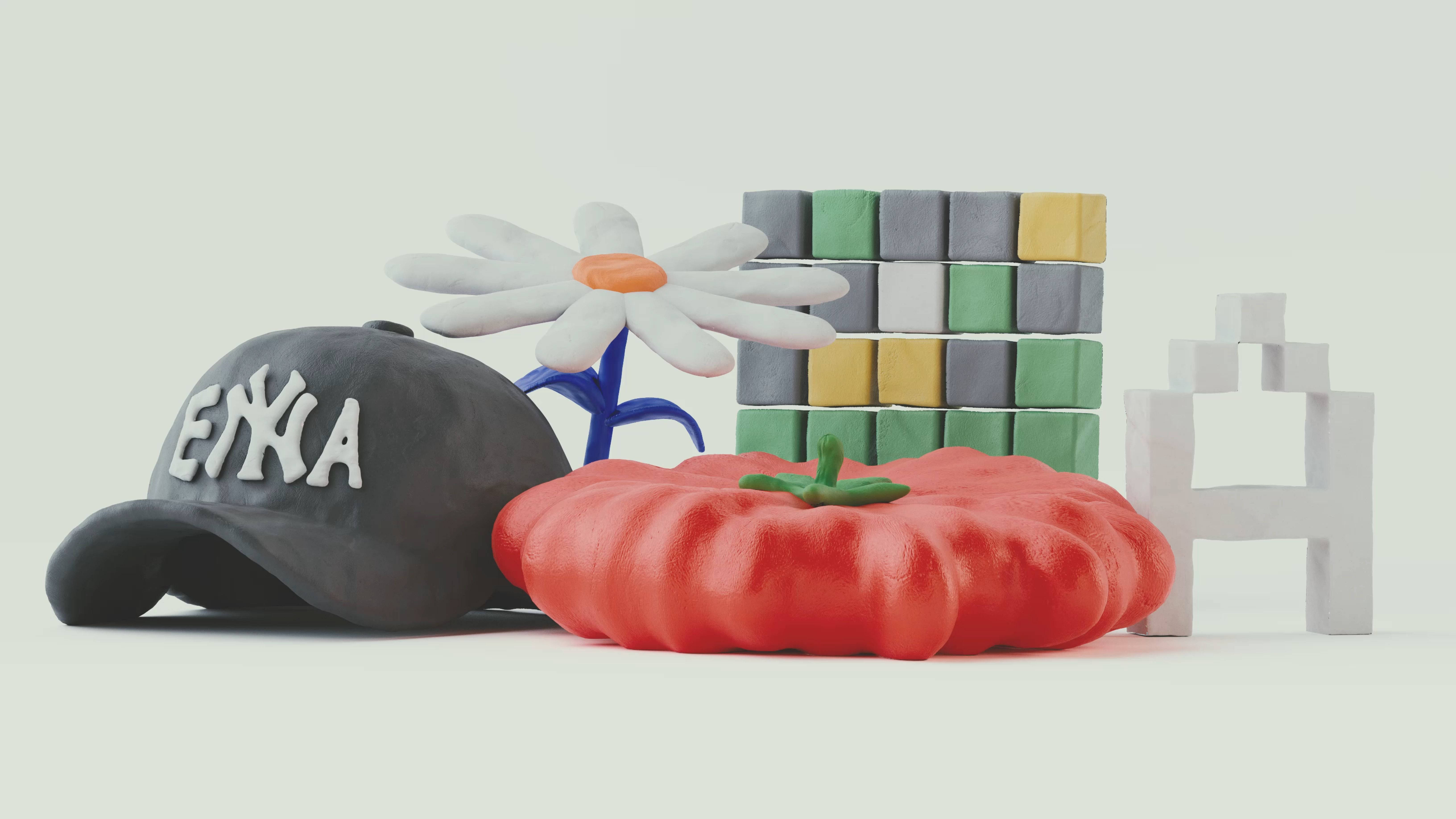 A colorful arrangement of clay sculptures, including a black baseball cap with "ENYA" written in white, a white daisy with an orange center on a blue stem, a red tomato, a stack of multicolored cube blocks (green, gray, white, and yellow), and a white abstract structure resembling a pixelated chair or figure. The background is a pale off-white, giving the objects a clean and minimalistic look.