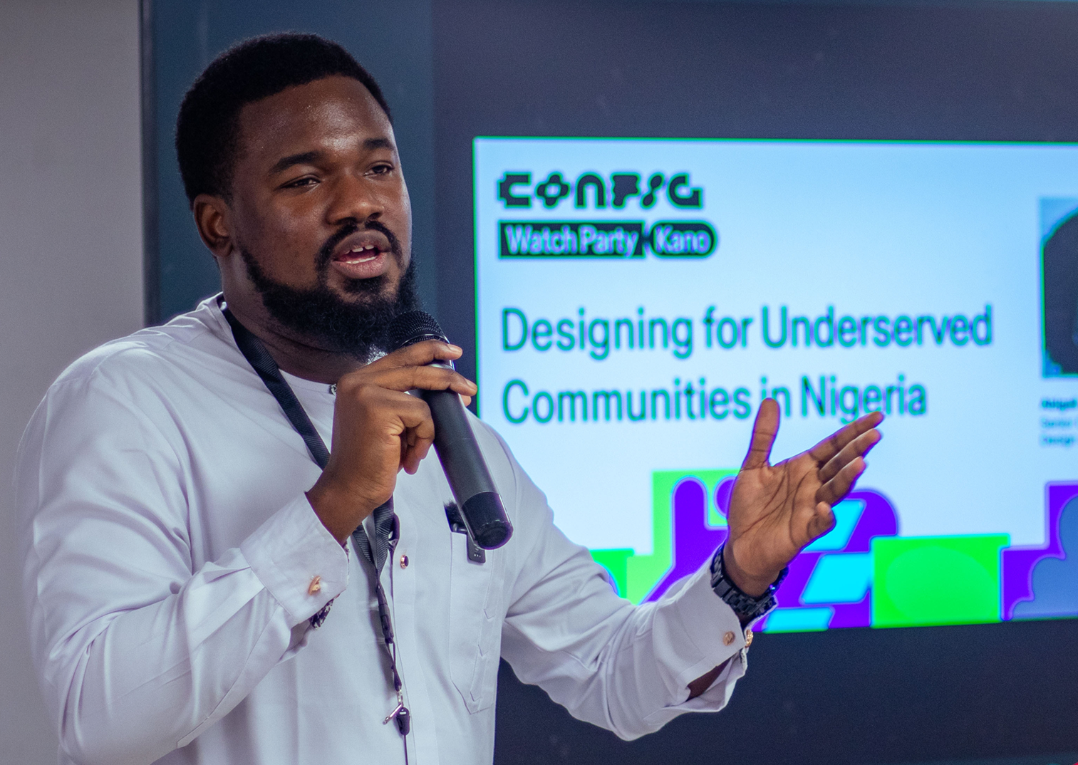 Individual speaks with microphone at event