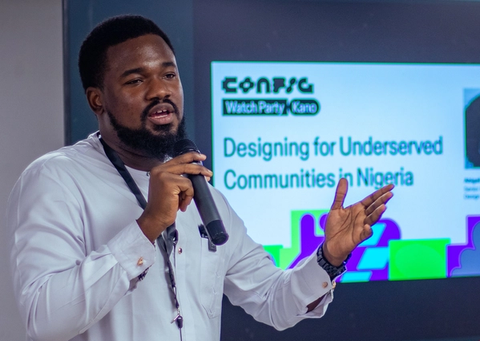 Individual speaks with microphone at event