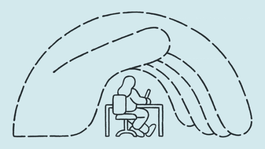 A hand is holding a person at a desk working