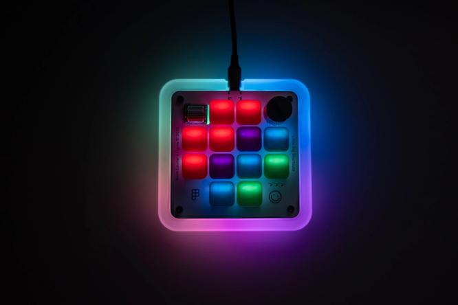 The Figma Creator Micro keyboard with glowing keycaps.