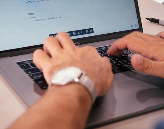 hands typing on a keyboard