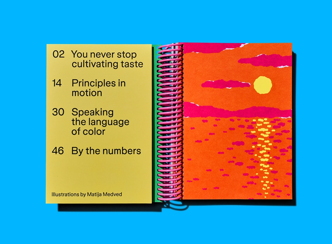 Colorful table of contents sits beside a vibrant sunset illustration across an open notebook spread.