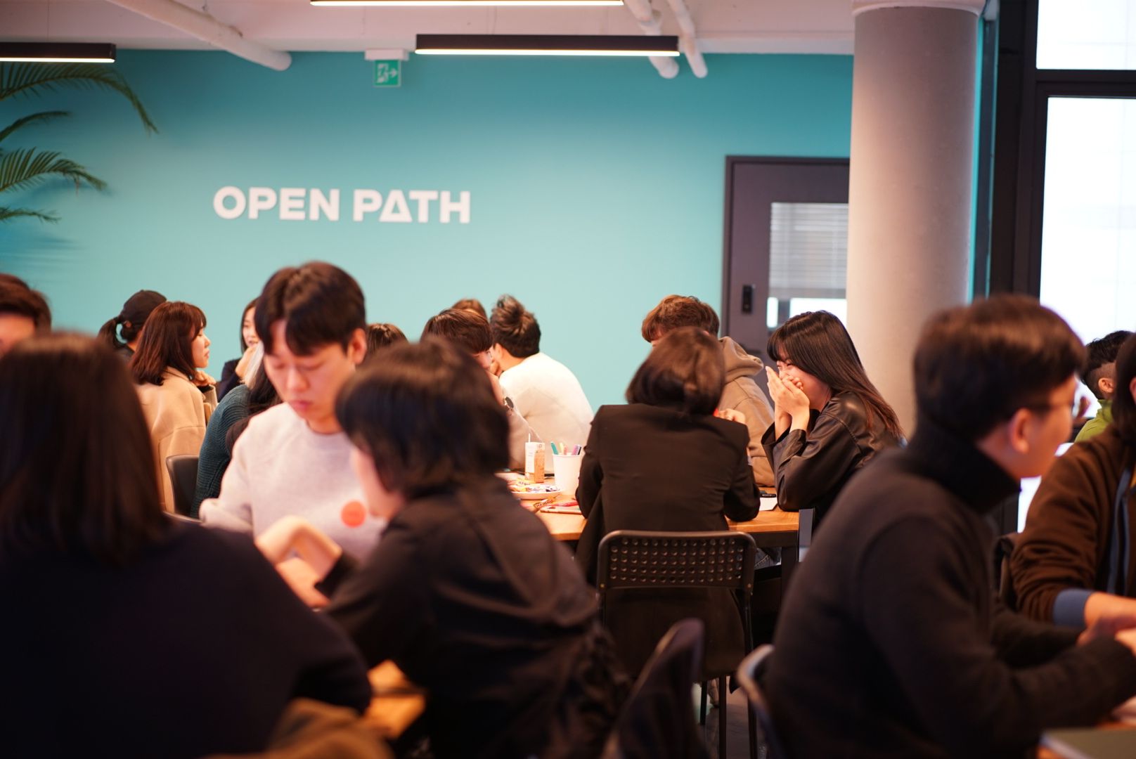 groups of people at tables at openpath office