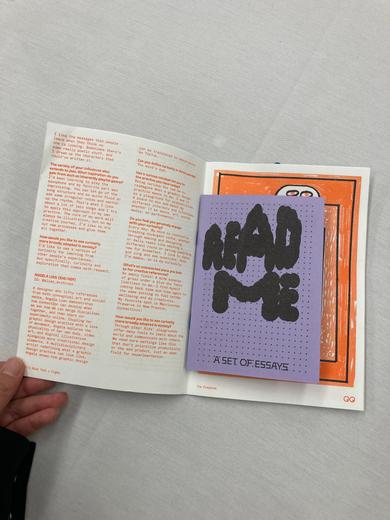 The zine opens to reveal a smaller booklet.