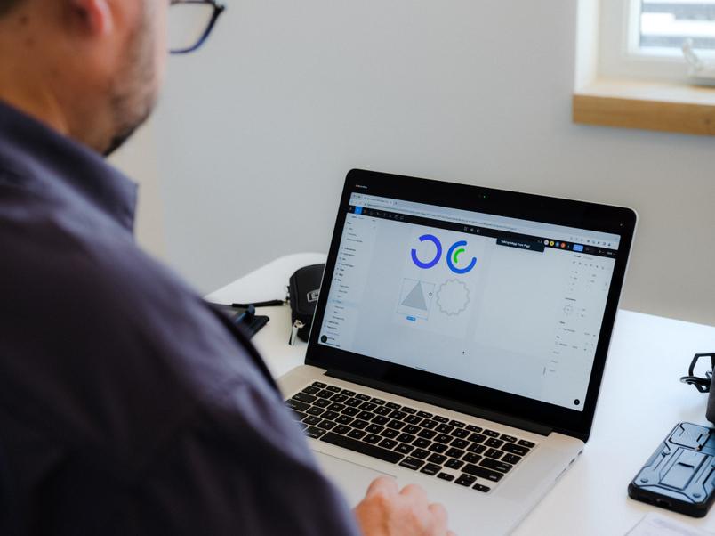 A fellow sits in front of a laptop that has Figma open