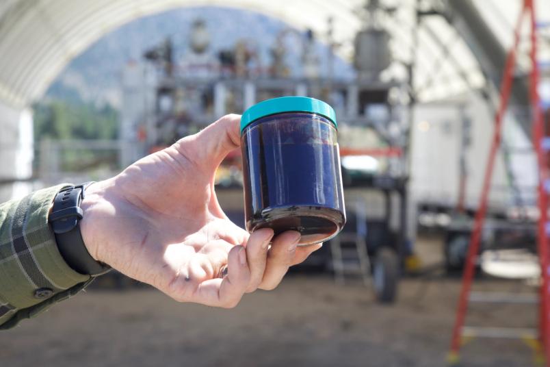 A photo of a jar full of tar-like bio-oil