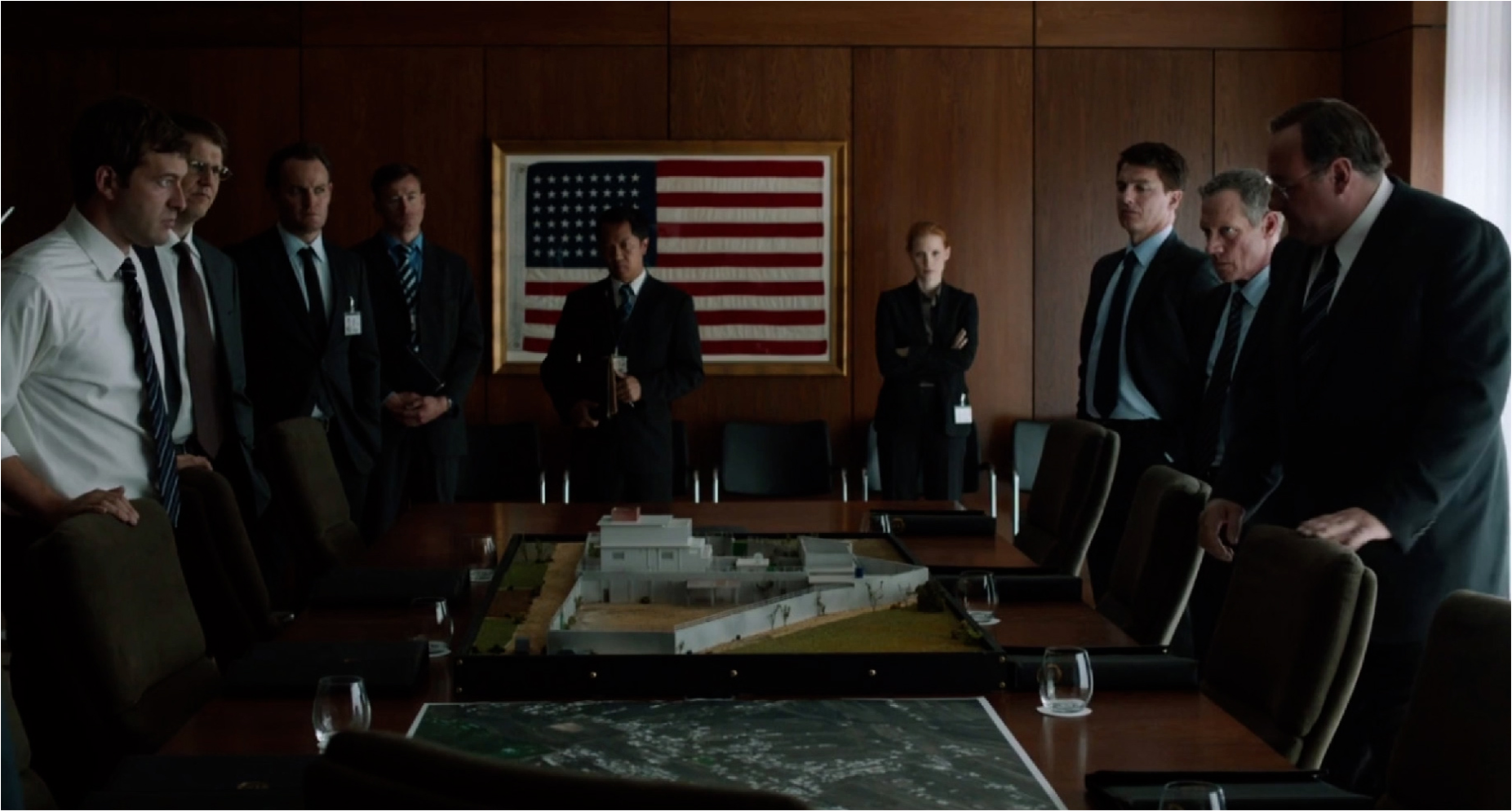Officials gather around a table model of a compound in Zero Dark Thirty.