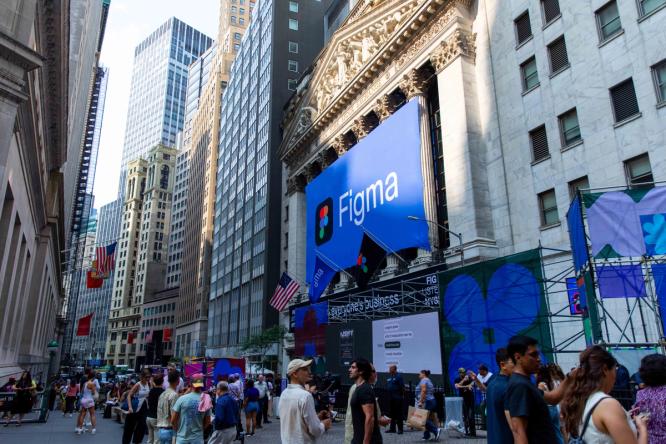 Crowd gathered outside the New York Stock Exchange beneath a massive Figma banner, surrounded by installations and street activations.