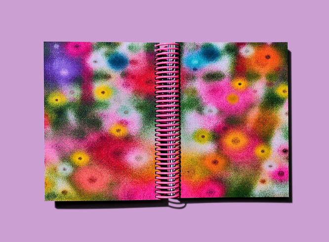 Full-bleed abstract floral artwork fills both pages of an open spiral-bound notebook.