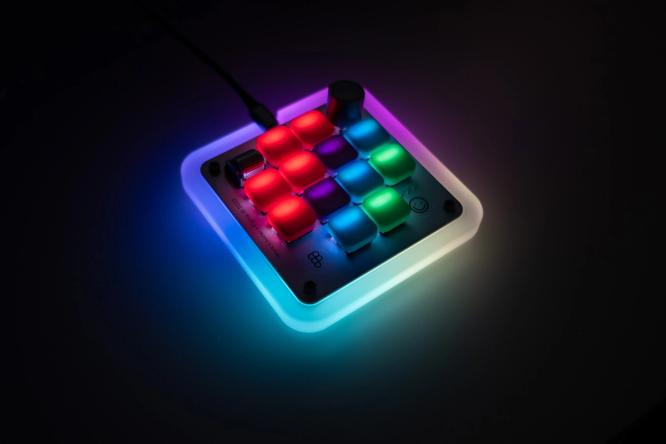The Figma Creator Micro keyboard with glowing keycaps.