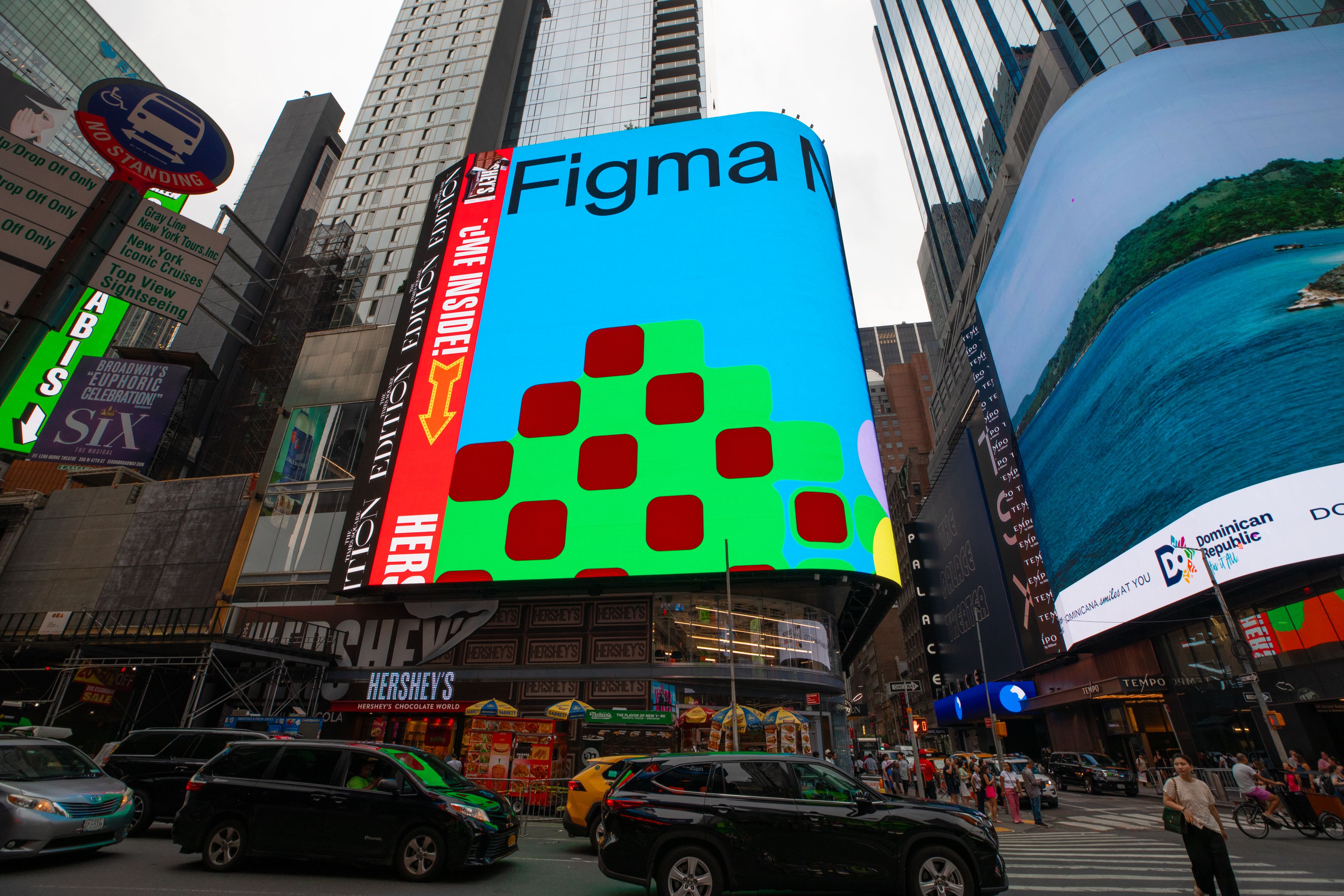 Large digital Figma Make ad displayed on a Times Square billboard, showing colorful stacked squares on a bright blue background.