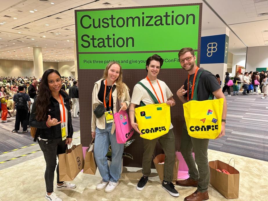Four friends pose with Config tote bags with various patches.