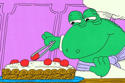 A cartoon frog chef carefully places cherries on top of a decorated cake with tongs.
