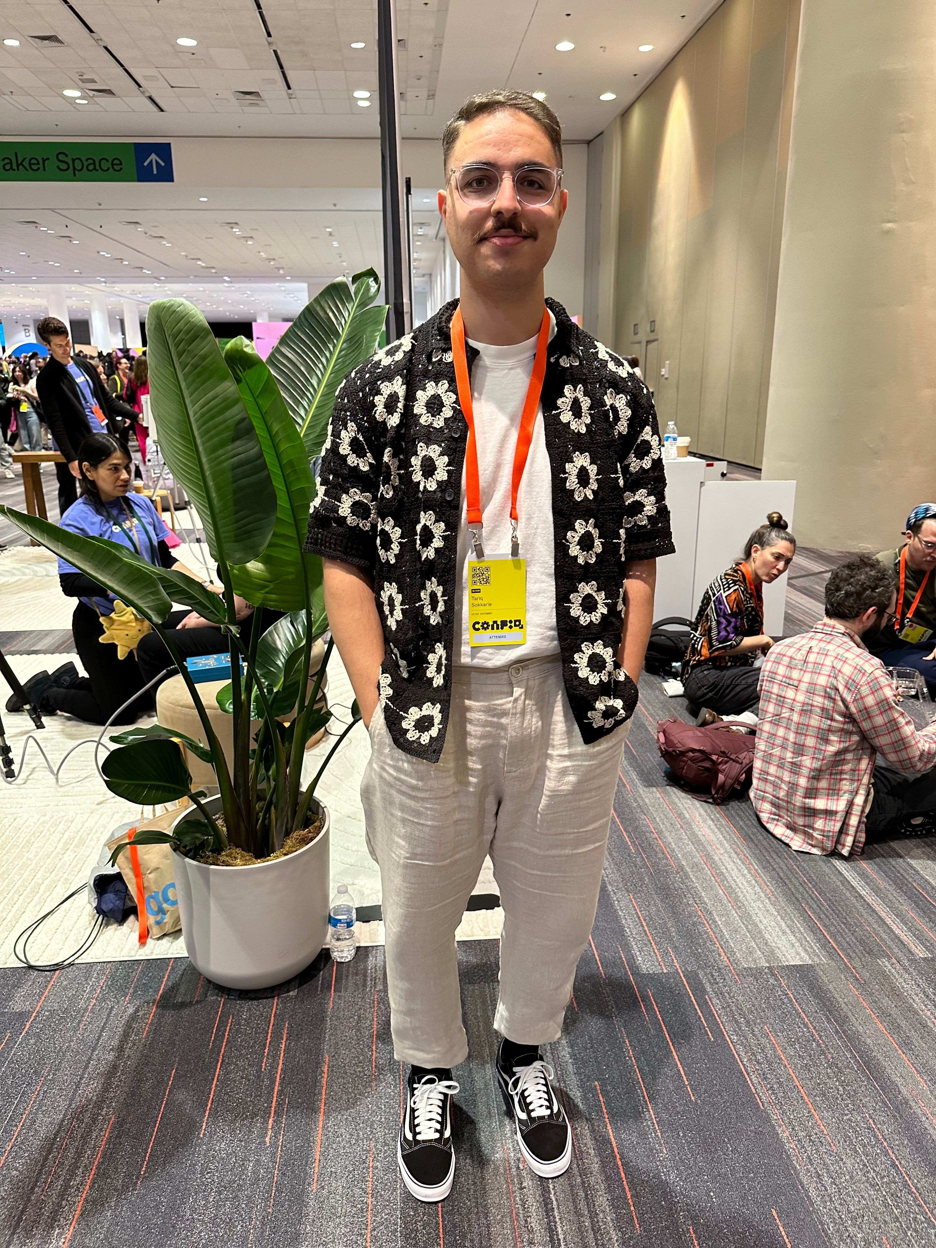 A man wears an open floral crochet button down