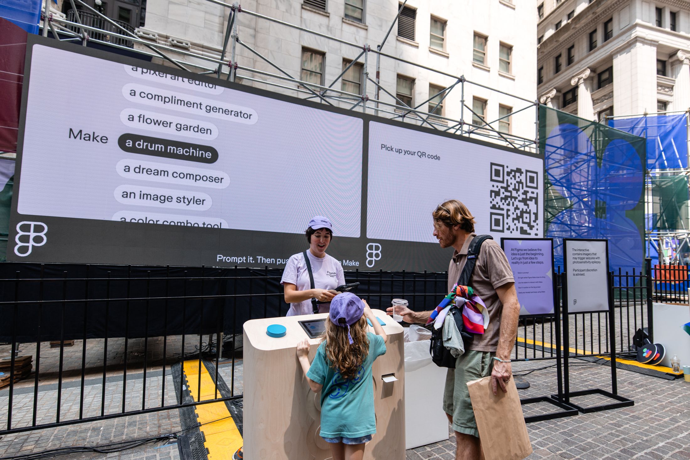 A family interacts with a Make station beneath a screen listing creative project prompts.