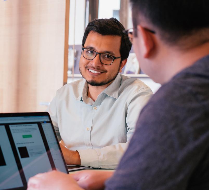 man giving a knowing smiling to collaborator
