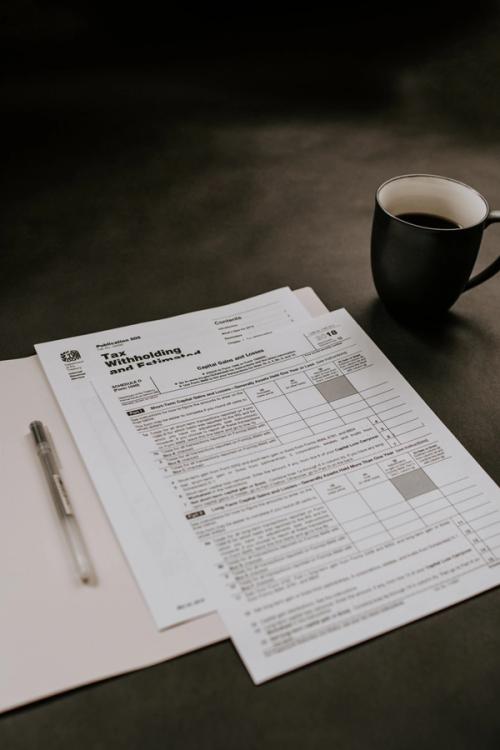 Tax return on the table with a coffee next to the documents