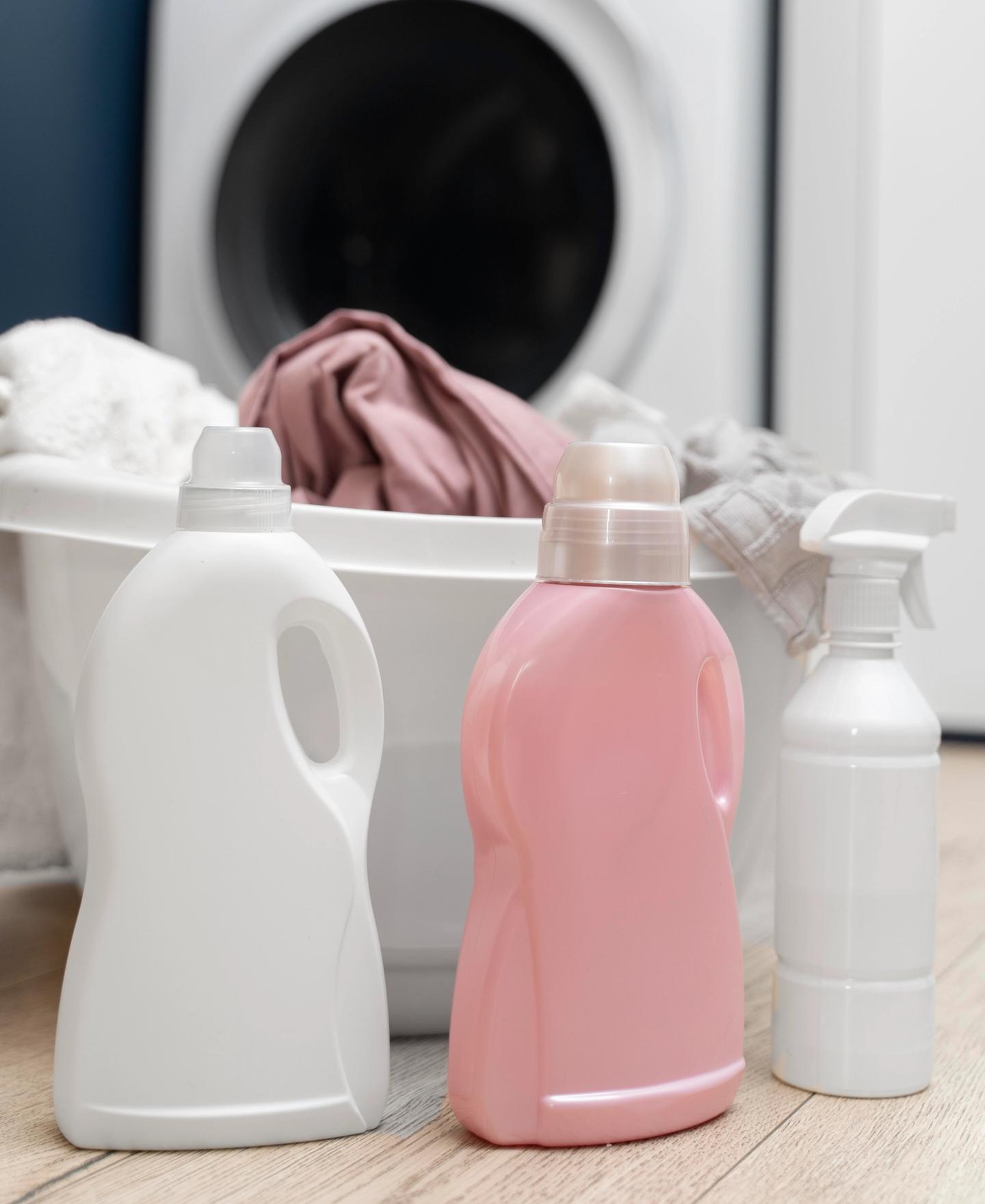 A laundry basket placed behind a range of clothes washing products.