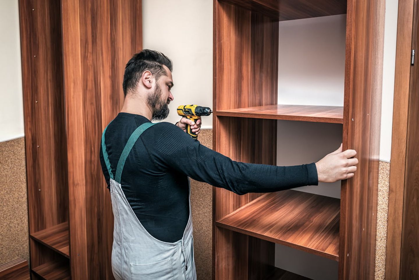 man fitting a diy wardrobe