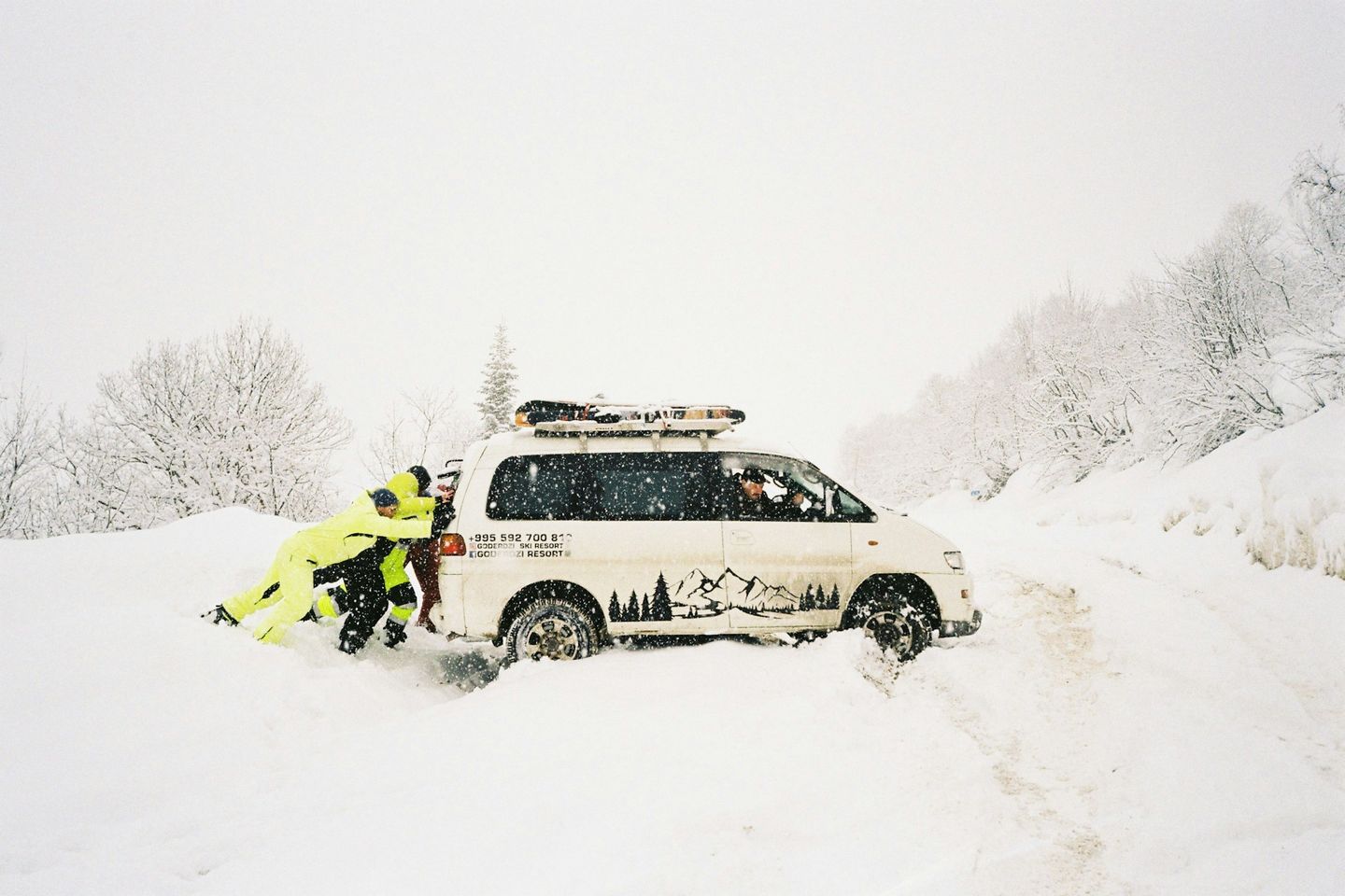 people pushing car from the ditch