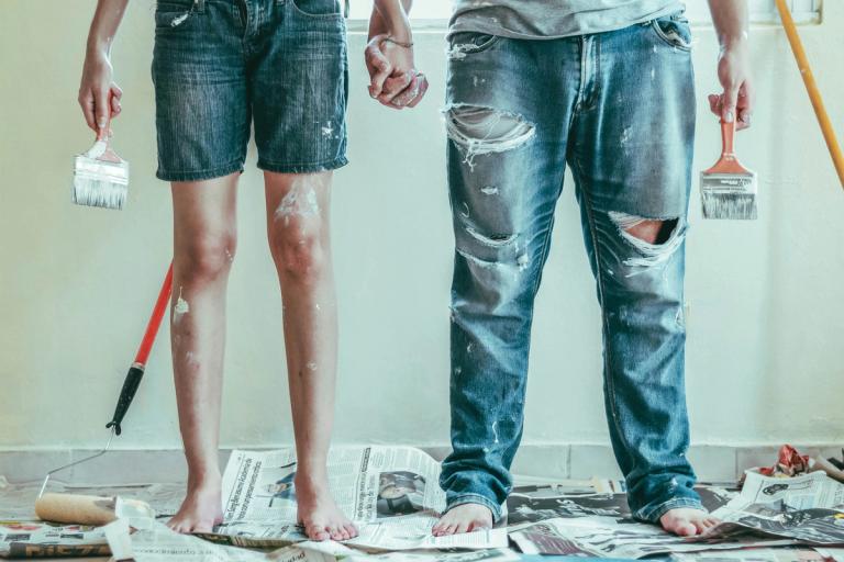 man and woman painting and holding hands