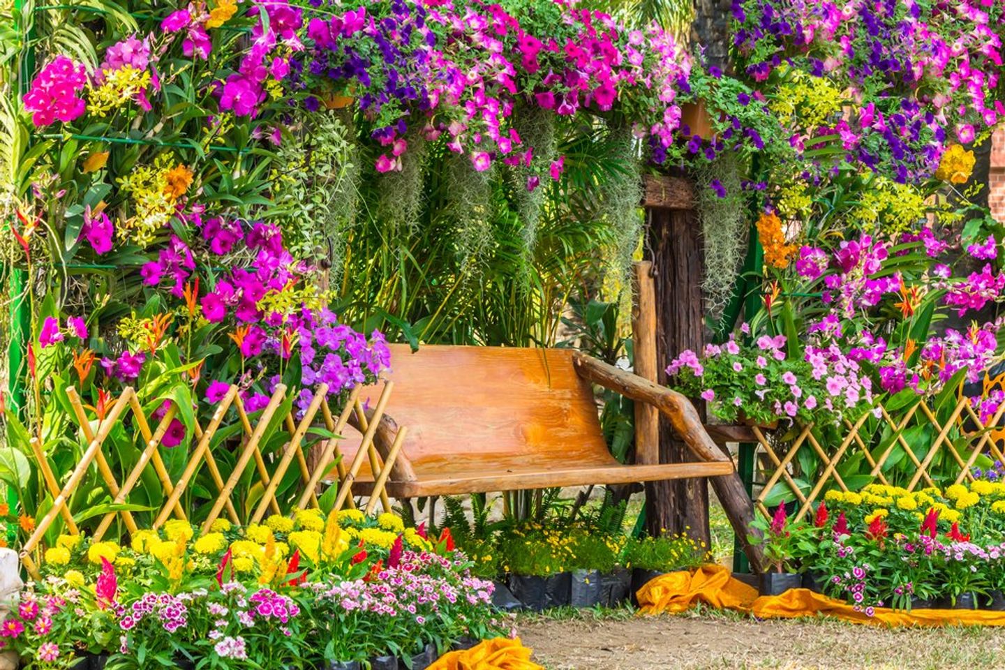 Garden bench surrounded by lush colorful flowers