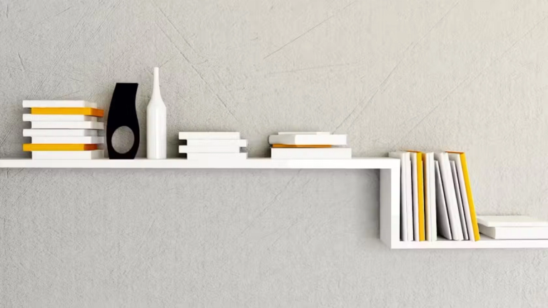 White shelves with several books and ornament on top.