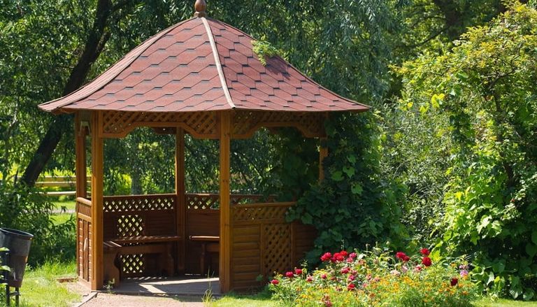 wooden garden diy summerhouse in a lush green garden