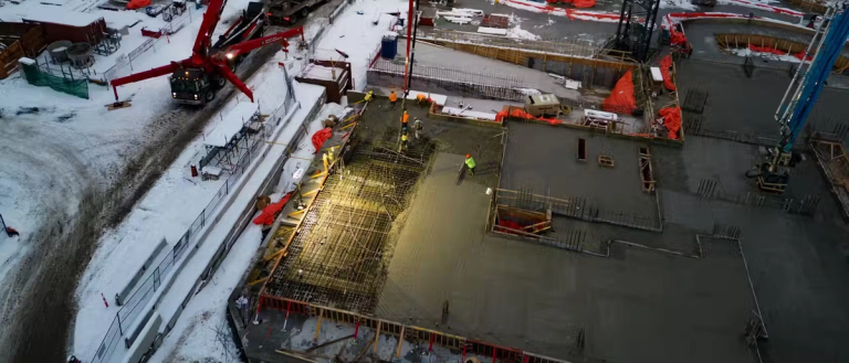 Dark construction site being lit up with bright lighting.