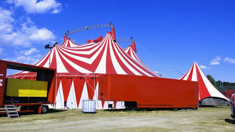 A large tent set up in a field for an outdoor event 