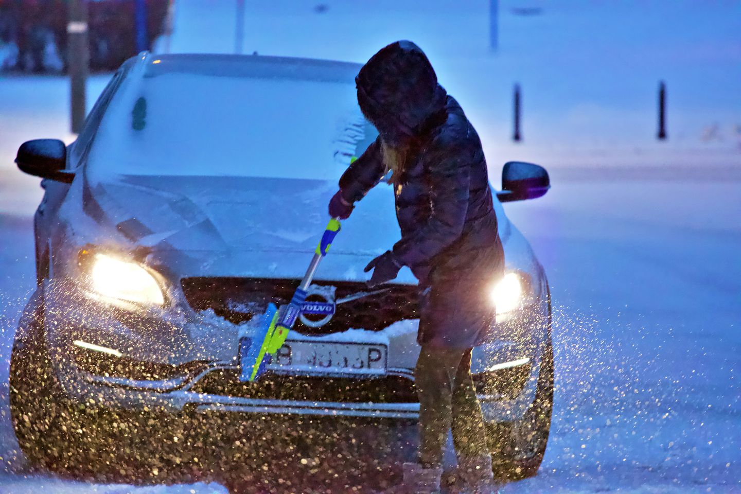 Scraping the snow on car