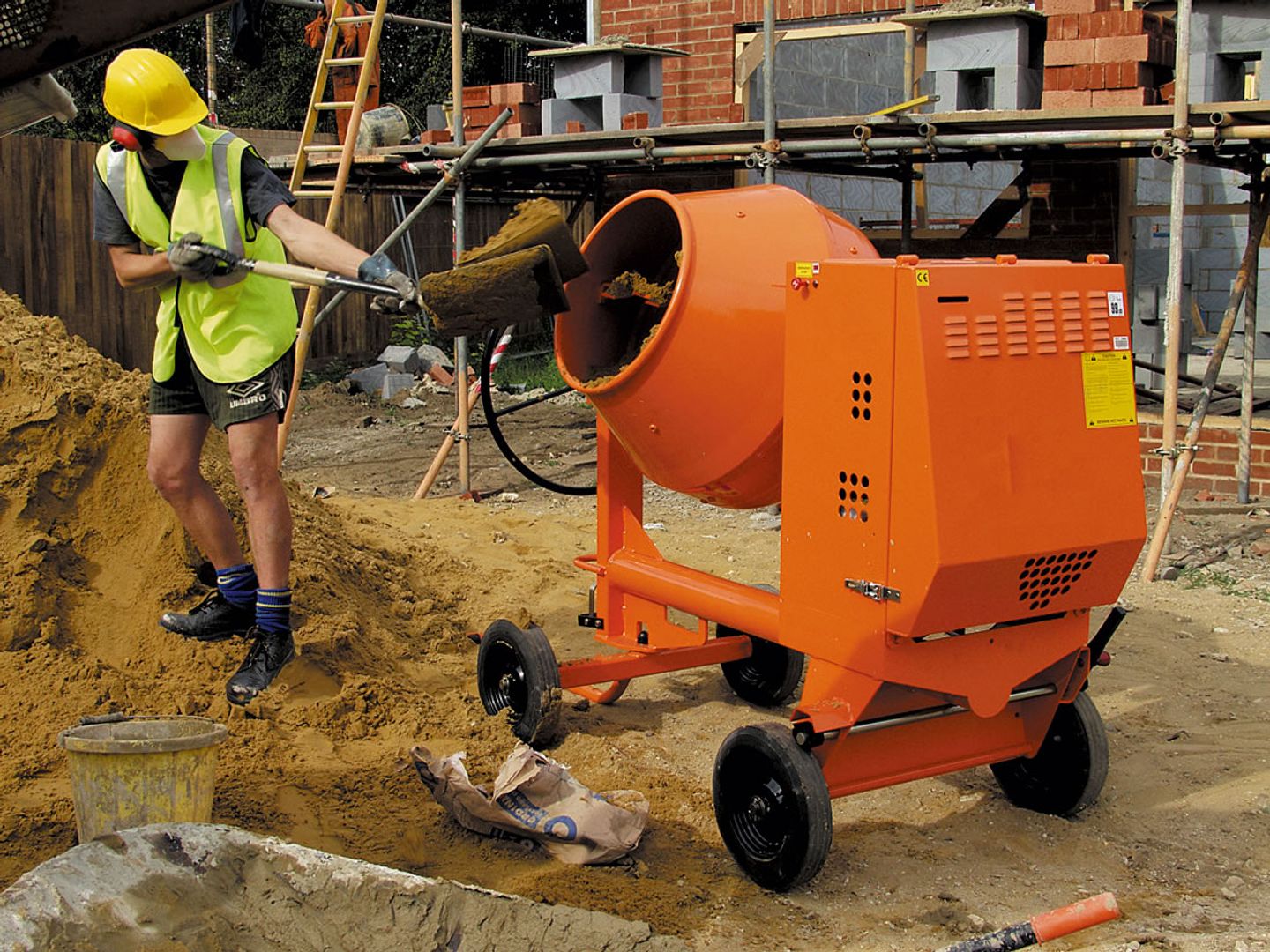 adding sand to the concrete mixer