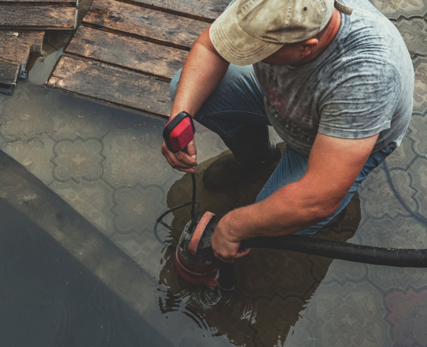 man using pump on a flooded ground