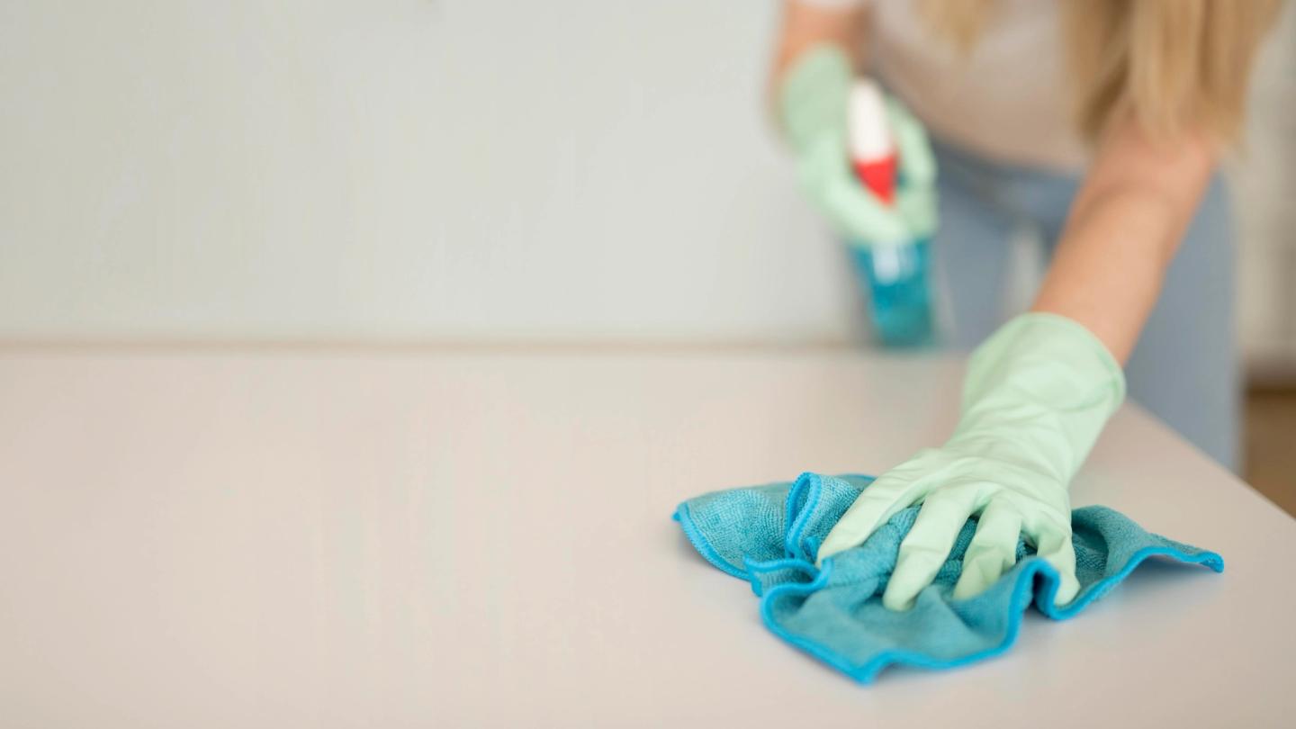 Woman cleaning a surface.