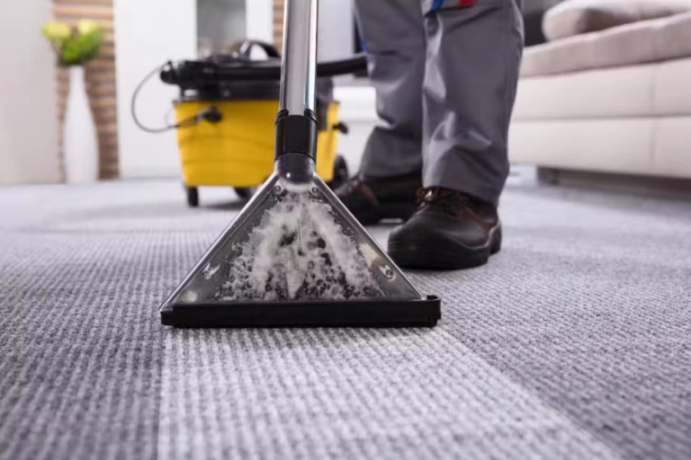 A carpet cleaner being used on a dirty carpet.