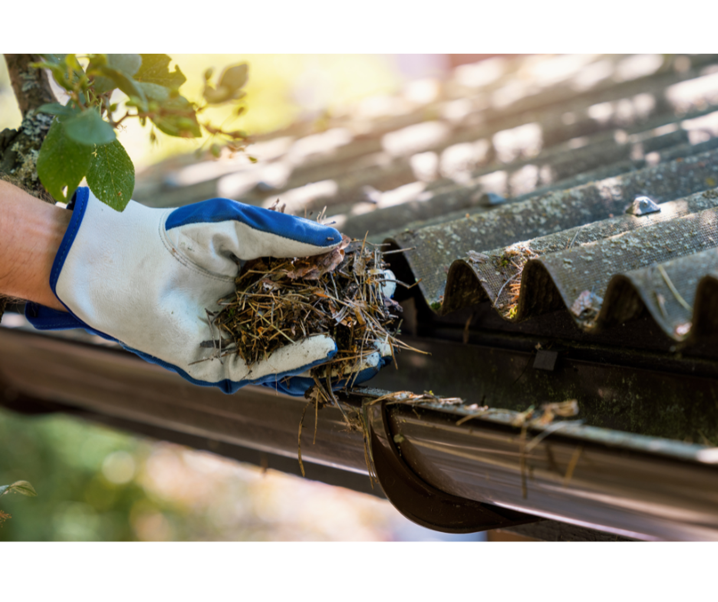 person cleaning the guttering system