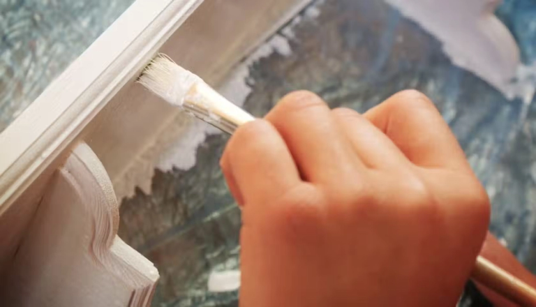 Someone painting a piece of furniture.