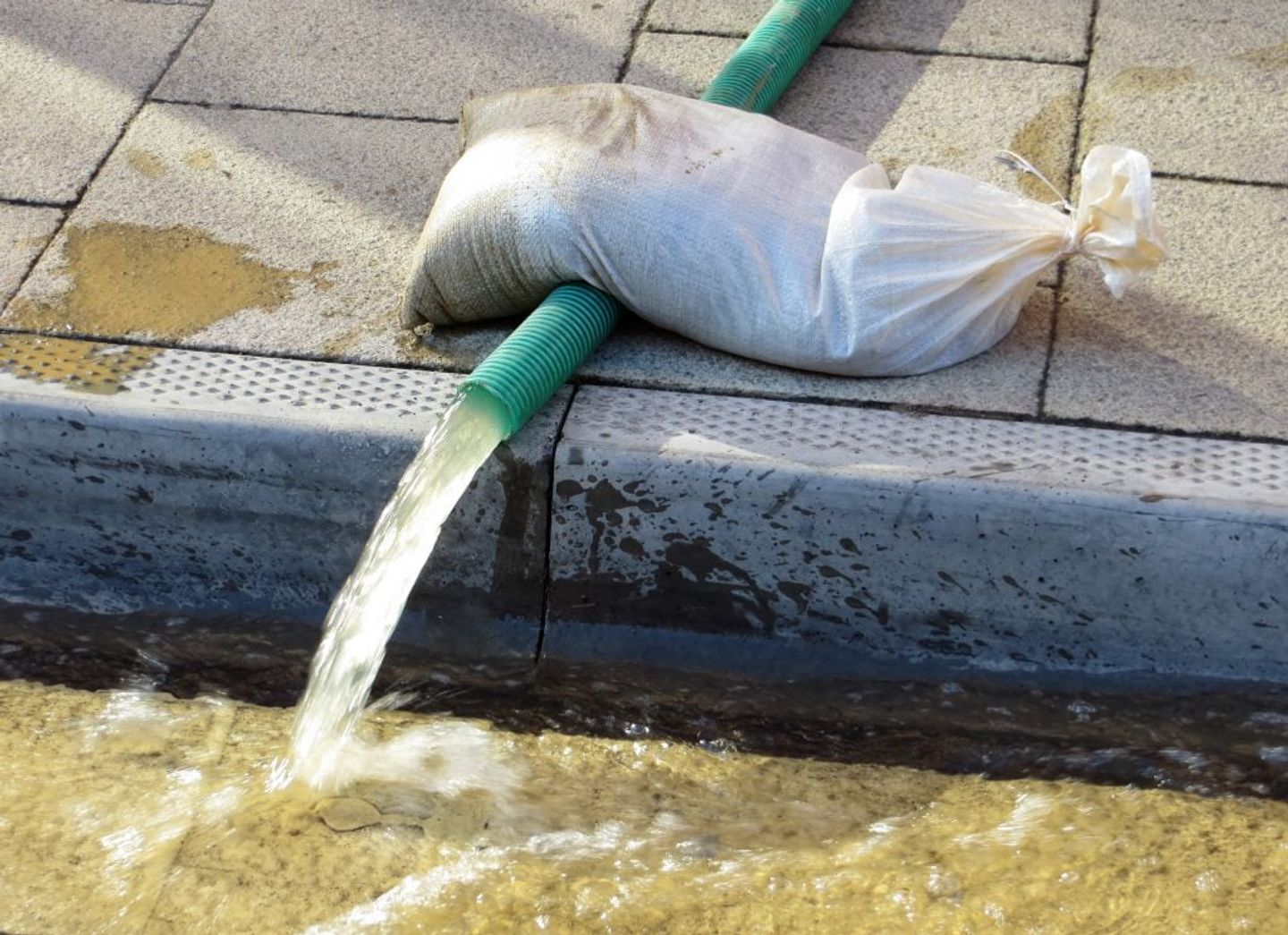 pcv pipe used for drying flood water held down by a sand bag