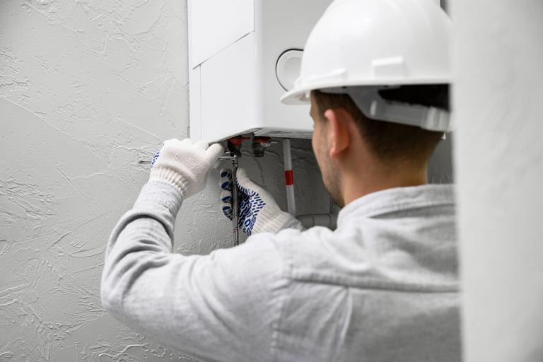 A person installing a new boiler