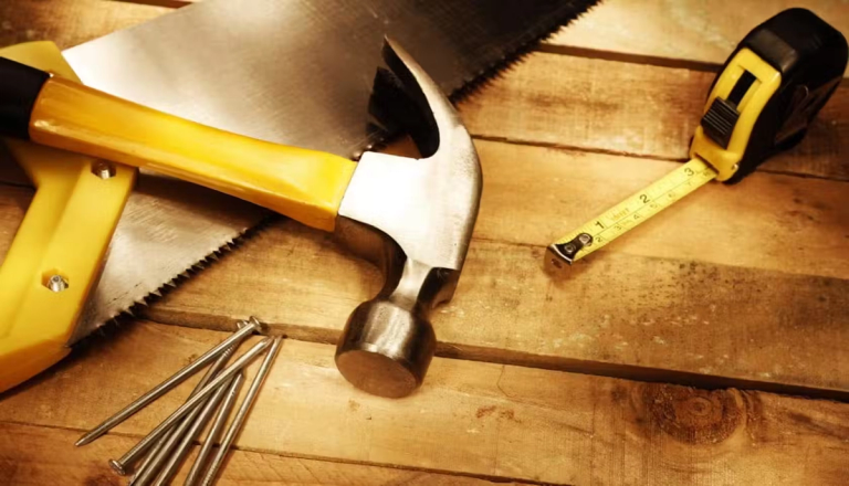 Hand tools laid on a wooden floor.