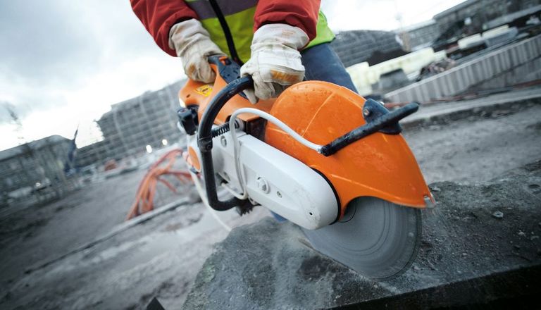 cutting a piece of concrete with a power saw