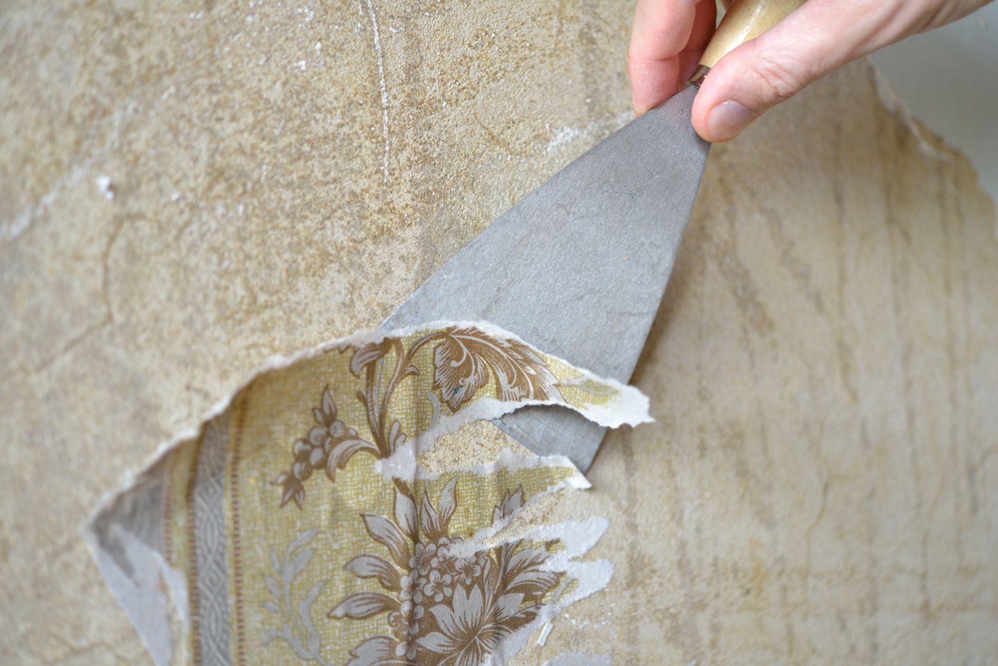 removing old wallpaper bits with scraper