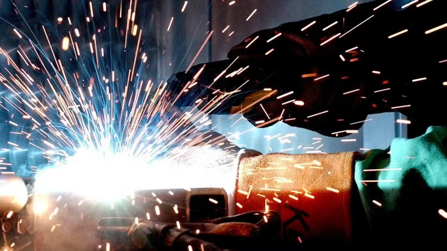 Construction worker on site who is welding.