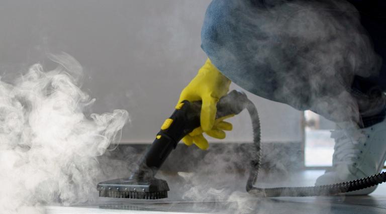 professional cleaning service person using steam cleaner office