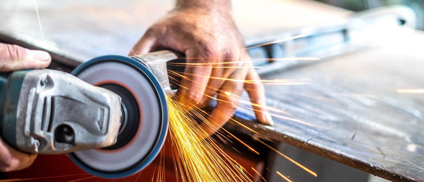 person using angle grinder