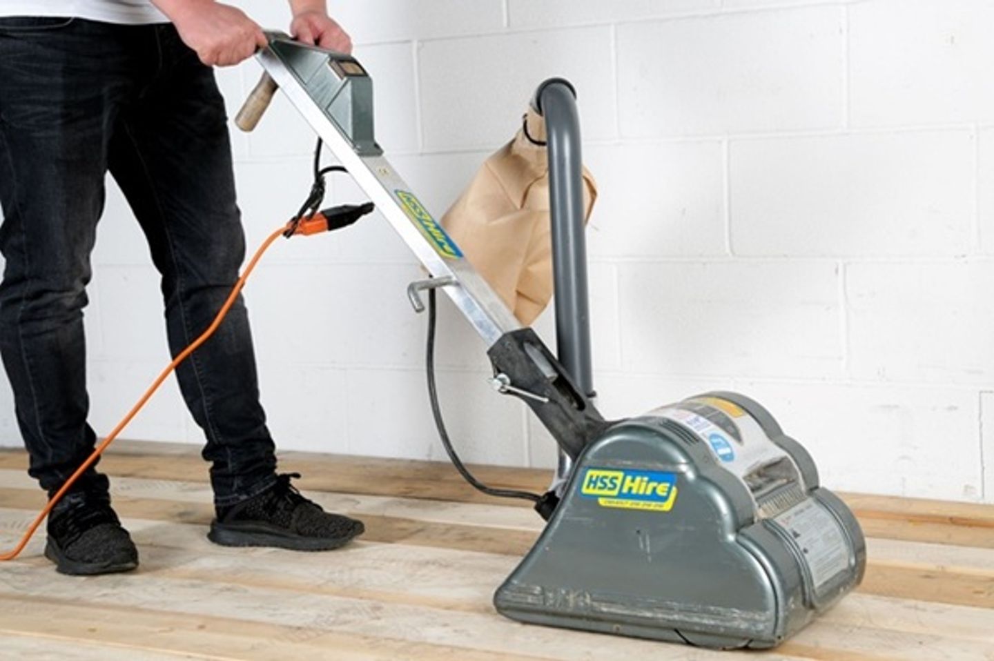 man using floor sander
