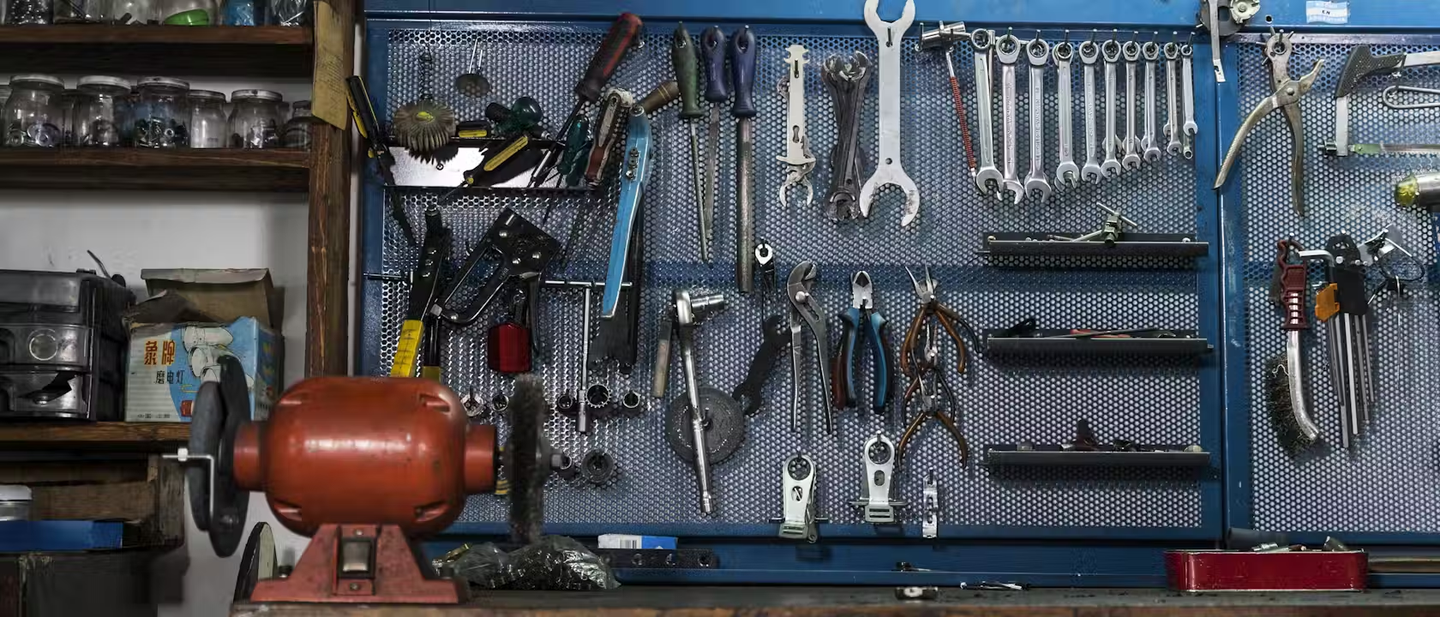 A range of tools hung up on a wall.